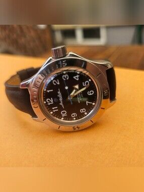 Vostok Amphibia 120811 watch featuring a distinct, matte black dial with white n
